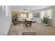 A living room boasts neutral tones, stylish decor, and large windows dressed with sheer curtains at 6727 E Washington Ave, Las Vegas, NV 89110