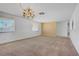 Bright living room with chandelier and tan accent wall at 6727 E Washington Ave, Las Vegas, NV 89110