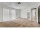 Large living room with plush carpet, access to other rooms, and a sliding door that provides ample light at 6727 E Washington Ave, Las Vegas, NV 89110
