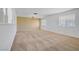Spacious carpeted living room with chandelier and natural light at 6727 E Washington Ave, Las Vegas, NV 89110