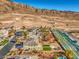 Aerial view of a community highlighting large backyards, lush landscaping, and mountain views at 6971 Cedar Basin Ave, Las Vegas, NV 89142