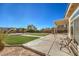 Covered patio overlooks a large backyard with green space and an entertainment area at 6971 Cedar Basin Ave, Las Vegas, NV 89142