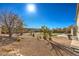 Expansive backyard featuring a lawn, landscaping, and clear blue skies at 6971 Cedar Basin Ave, Las Vegas, NV 89142