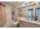 Well-lit bathroom with a shower-tub combination and extended vanity at 6971 Cedar Basin Ave, Las Vegas, NV 89142