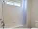 Bright bathroom showcasing tiled shower with a shower head and small window at 6971 Cedar Basin Ave, Las Vegas, NV 89142
