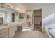 Bathroom featuring double sinks and a bathtub in the background at 6971 Cedar Basin Ave, Las Vegas, NV 89142