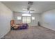 Spacious carpeted bedroom features a ceiling fan and natural light at 6971 Cedar Basin Ave, Las Vegas, NV 89142