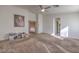 Large bedroom with carpet flooring, neutral walls, and access to other areas in the home at 6971 Cedar Basin Ave, Las Vegas, NV 89142
