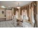 Bright dining room with a modern table set, tiled floors, and stylish window treatments for a refined dining experience at 6971 Cedar Basin Ave, Las Vegas, NV 89142