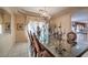 Formal dining area features a glass table and chandelier, ideal for entertaining at 6971 Cedar Basin Ave, Las Vegas, NV 89142
