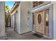 Inviting front entry features a wooden door with glass panels and elegant sconces at 6971 Cedar Basin Ave, Las Vegas, NV 89142