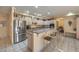 Spacious kitchen with granite counters, a breakfast bar, stainless steel appliances, and tile flooring at 6971 Cedar Basin Ave, Las Vegas, NV 89142