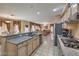 Modern kitchen with granite countertops, stainless appliances, and an open layout that connects to the living area at 6971 Cedar Basin Ave, Las Vegas, NV 89142