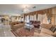 Open-concept living room featuring tile flooring, a chandelier, and neutral-toned sofas for a comfortable space at 6971 Cedar Basin Ave, Las Vegas, NV 89142