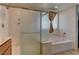 Bathroom boasting a large shower and separate soaking tub with tile surround at 7104 Flathead River Ave, Las Vegas, NV 89179