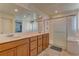 Bright bathroom featuring double sinks, and a large glass enclosed shower at 7104 Flathead River Ave, Las Vegas, NV 89179