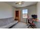 Bright bedroom featuring a futon, built in shelves, and a desk next to the window at 7104 Flathead River Ave, Las Vegas, NV 89179