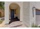 Covered entrance with brick flooring, and a textured stucco wall at 7104 Flathead River Ave, Las Vegas, NV 89179