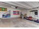 Spacious garage with painted concrete floor, fluorescent lights, and ample storage space at 7104 Flathead River Ave, Las Vegas, NV 89179