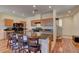 Kitchen featuring a granite countertop island with barstool seating and wood cabinets at 7104 Flathead River Ave, Las Vegas, NV 89179