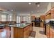 Kitchen featuring a granite countertop island with barstool seating opening up to the living room and dining room at 7104 Flathead River Ave, Las Vegas, NV 89179