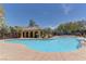 Community pool features cool blue water, with a yellow-toned community building in the background at 7104 Flathead River Ave, Las Vegas, NV 89179