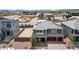 Two-story home featuring a brick driveway, three-car garage, solar panels, and desert landscaping at 7255 Bold Rock Ave, Las Vegas, NV 89113