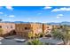 Aerial view of the building showcasing the facade, garages, desert landscaping, and the surrounding community at 728 Hardy Way # E, Mesquite, NV 89027