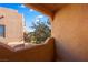 Cozy balcony with stucco walls offers views of the surrounding landscape and clear, blue sky at 728 Hardy Way # E, Mesquite, NV 89027
