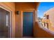 An inviting balcony with stucco architectural elements overlooks neighboring buildings and blue skies at 728 Hardy Way # E, Mesquite, NV 89027