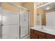 Bathroom features modern walk-in shower with glass enclosure, wood vanity and modern faucet at 728 Hardy Way # E, Mesquite, NV 89027