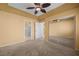 Bright bedroom features carpet, ensuite bath, walk-in closet, fan and large window with shutters at 728 Hardy Way # E, Mesquite, NV 89027
