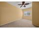 A well-lit bedroom features neutral carpet, window with shutters, and modern ceiling fan at 728 Hardy Way # E, Mesquite, NV 89027