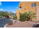 Exterior of the building highlighting the facade, palm trees, landscaping, and entry stairs at 728 Hardy Way # E, Mesquite, NV 89027
