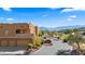 Exterior of stucco apartment buildings with garages, complemented by desert landscaping and mountain views at 728 Hardy Way # E, Mesquite, NV 89027