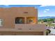 Exterior view highlighting the stucco facade, windows, patio, and mountain views in the background at 728 Hardy Way # E, Mesquite, NV 89027