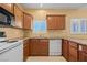 Well-equipped kitchen offering wood cabinetry, granite countertops, and sleek appliances, designed for both aesthetics and practicality at 728 Hardy Way # E, Mesquite, NV 89027