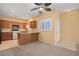 Well-lit kitchen featuring light-colored walls, wood cabinetry, a breakfast bar, and an adjacent doorway, creating a cozy atmosphere at 728 Hardy Way # E, Mesquite, NV 89027