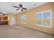 Bright living room featuring neutral paint, ceiling fans, a view into the kitchen, and shutters at 728 Hardy Way # E, Mesquite, NV 89027