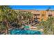 Beautiful community pool with palm trees and a hot tub, perfect for relaxing and enjoying the desert scenery at 728 Hardy Way # E, Mesquite, NV 89027
