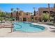 Inviting community pool with a tanning deck and desert landscaping, ideal for summertime relaxation at 728 Hardy Way # E, Mesquite, NV 89027