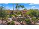 Beautiful water feature with lush tropical landscaping and palm trees, set against an apartment complex at 728 Hardy Way # E, Mesquite, NV 89027