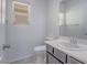 Bathroom featuring a toilet, sink, vanity, and window at 7753 Petite Pillar Ct, Las Vegas, NV 89149