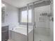 Bright bathroom showcasing soaking tub and separate shower with glass door at 7753 Petite Pillar Ct, Las Vegas, NV 89149