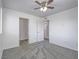Spacious bedroom featuring neutral carpet, ceiling fan, and ensuite bathroom and walk in closet at 7753 Petite Pillar Ct, Las Vegas, NV 89149