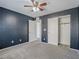 Bedroom features dark blue accent wall, neutral carpet, and closet at 7753 Petite Pillar Ct, Las Vegas, NV 89149