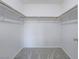 Spacious walk-in closet features neutral carpet and wood closet rods at 7753 Petite Pillar Ct, Las Vegas, NV 89149