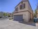 Nice exterior of townhome with an attached garage and a neatly landscaped front yard at 7753 Petite Pillar Ct, Las Vegas, NV 89149
