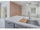 Bright kitchen island with sink and stainless steel dishwasher at 7753 Petite Pillar Ct, Las Vegas, NV 89149