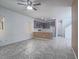 Living room open to kitchen featuring modern tile flooring, ample natural light, and stylish finishes at 7753 Petite Pillar Ct, Las Vegas, NV 89149